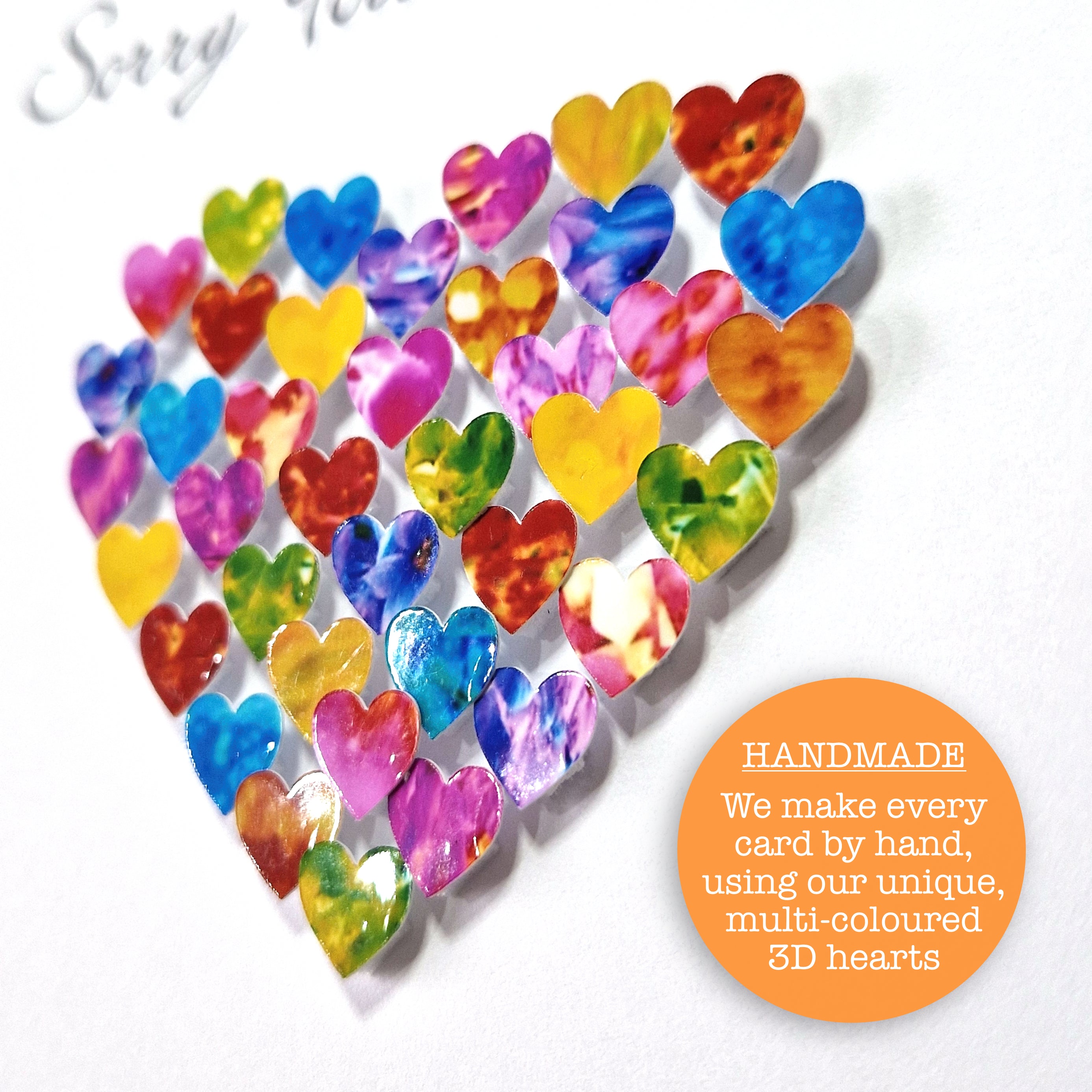 close up detail again of colourful hearts in the shape of a larger heart on a white background