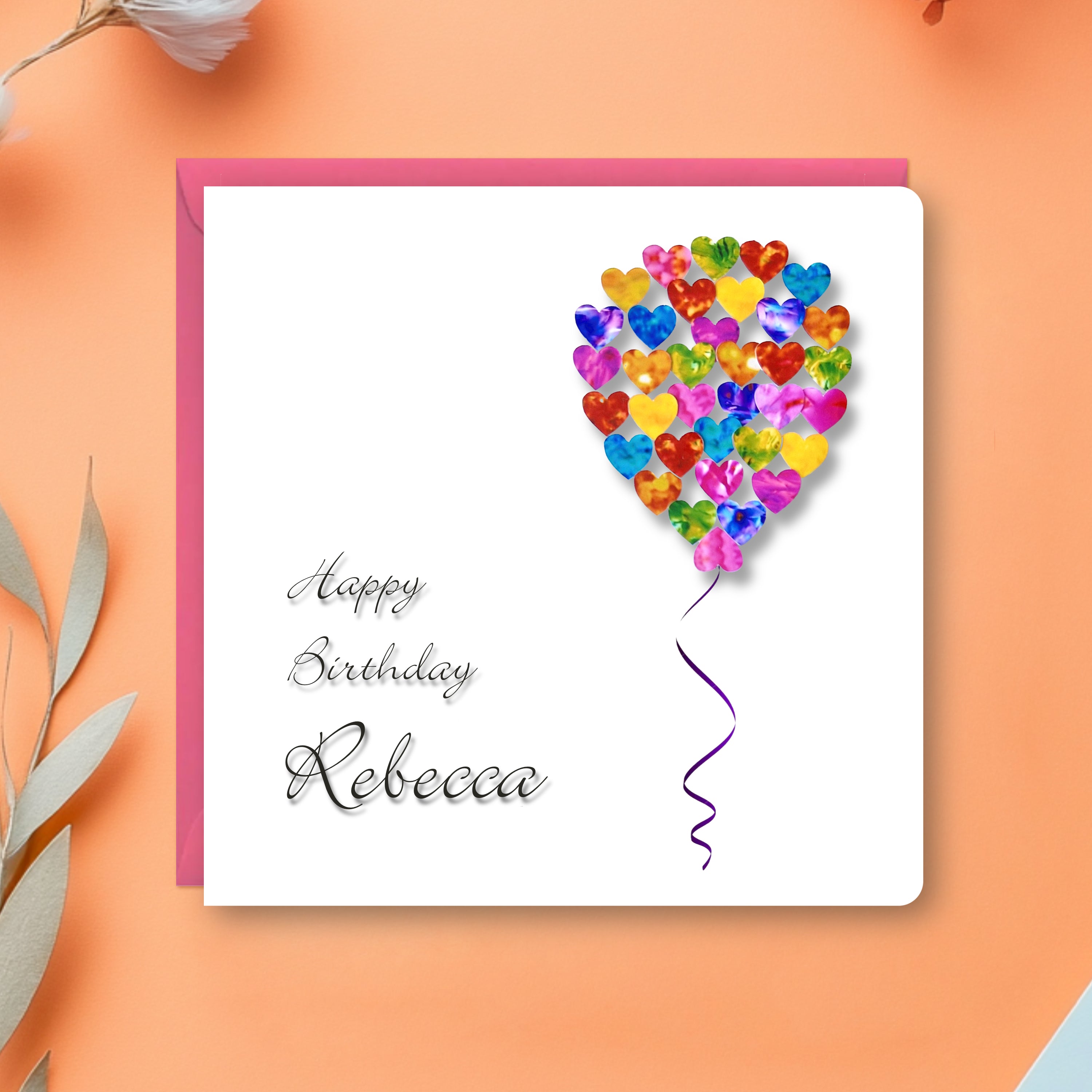 Personalised Birthday card with colourful hearts shaped as a balloon and 'Happy Birthday Rebecca' text on a peach background